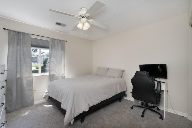 bedroom featuring carpet, baseboards, a ceiling fan, and a desk