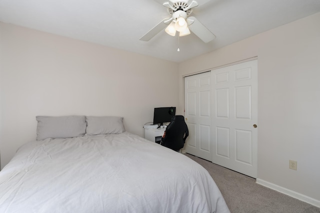carpeted bedroom with a closet, ceiling fan, and baseboards