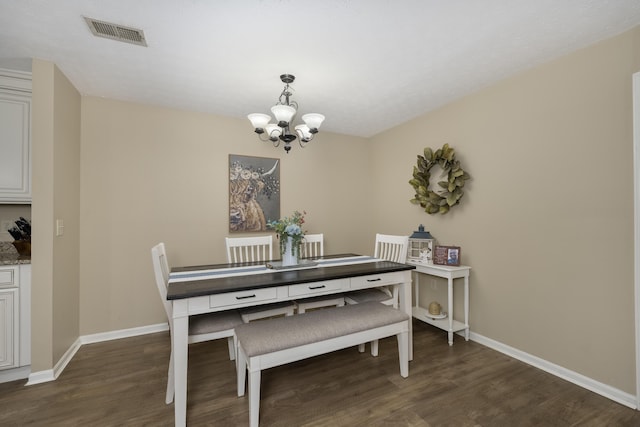 dining room with a chandelier, dark wood-style flooring, and baseboards