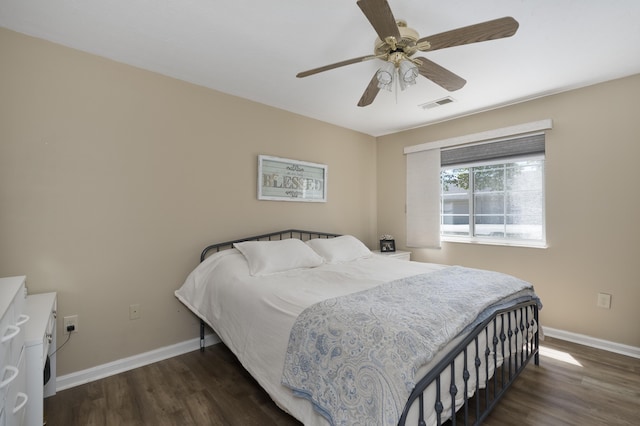 bedroom featuring wood finished floors, baseboards, and a ceiling fan