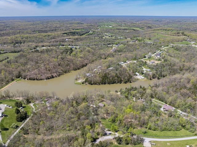 drone / aerial view featuring a water view and a forest view
