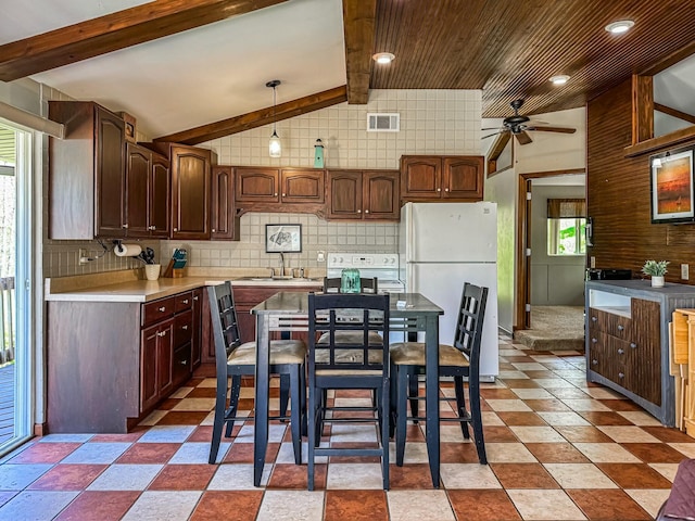 kitchen featuring a sink, a ceiling fan, backsplash, and white appliances