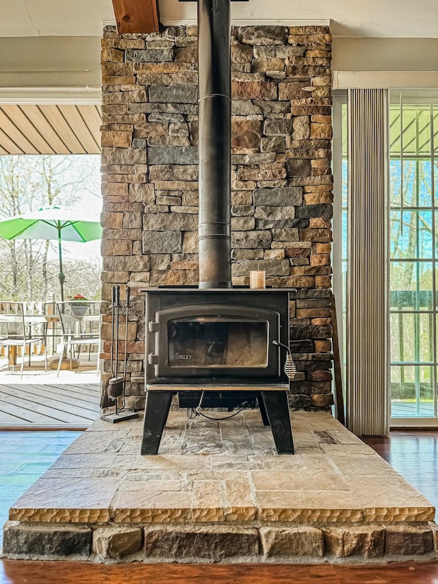 room details with a wood stove and wood finished floors