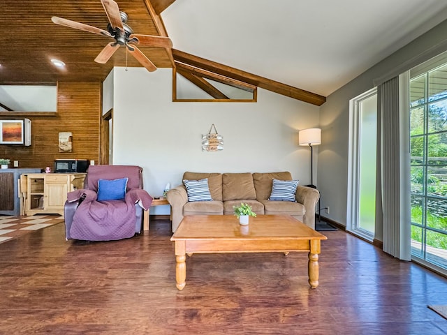living room with a ceiling fan, vaulted ceiling, and wood finished floors