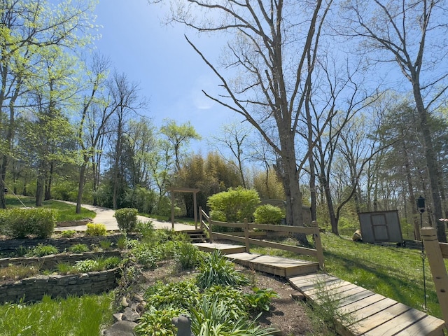 view of home's community featuring a storage unit and an outdoor structure