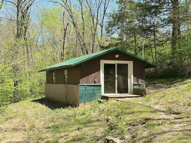 view of outdoor structure with a view of trees and an outdoor structure