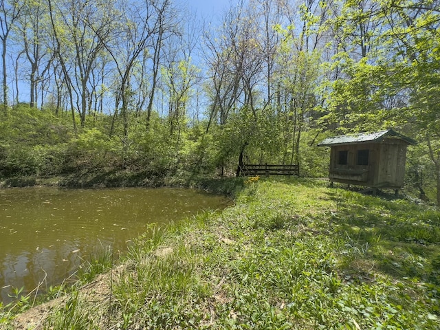 view of yard featuring a storage shed and an outbuilding