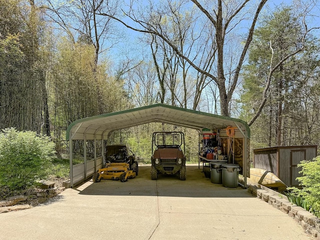 view of vehicle parking with a storage unit, a detached carport, and concrete driveway