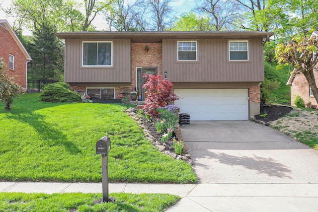 48 Bonnie Ln, Fort Thomas, KY 41075 - bi-level home featuring a front yard, a garage, driveway, brick siding, and fence