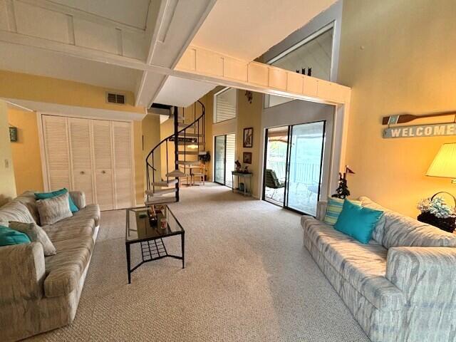 40 Fairway Ct Unit 14, Perry Park, KY 40363 - carpeted living room featuring visible vents, beamed ceiling, and stairs