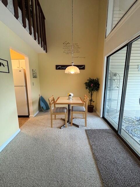 40 Fairway Ct Unit 14, Perry Park, KY 40363 - dining area with a high ceiling, light carpet, and baseboards