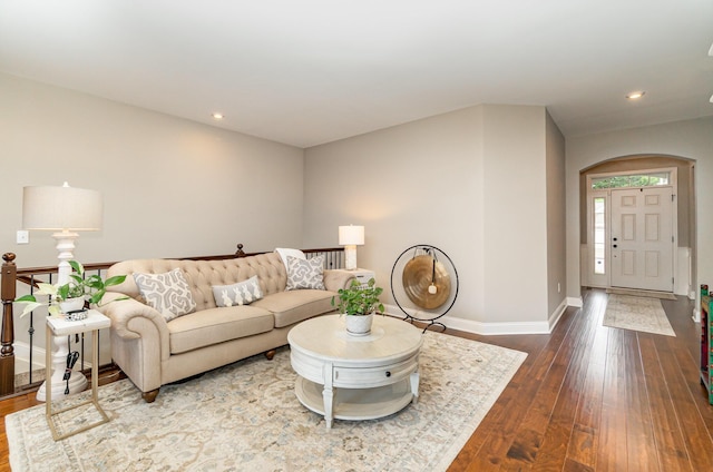 living room with recessed lighting, baseboards, and dark wood-type flooring