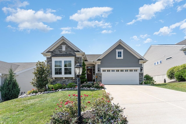 craftsman house featuring a front lawn, driveway, stone siding, and a garage