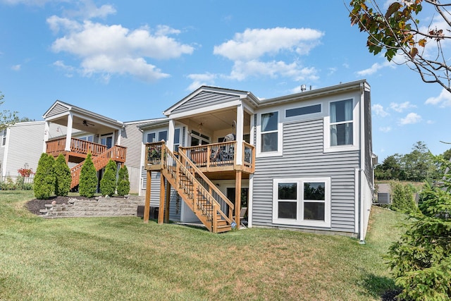 rear view of property with a lawn, stairs, ceiling fan, and a wooden deck