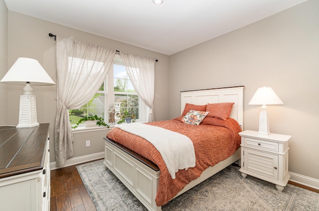 bedroom with wood finished floors and baseboards