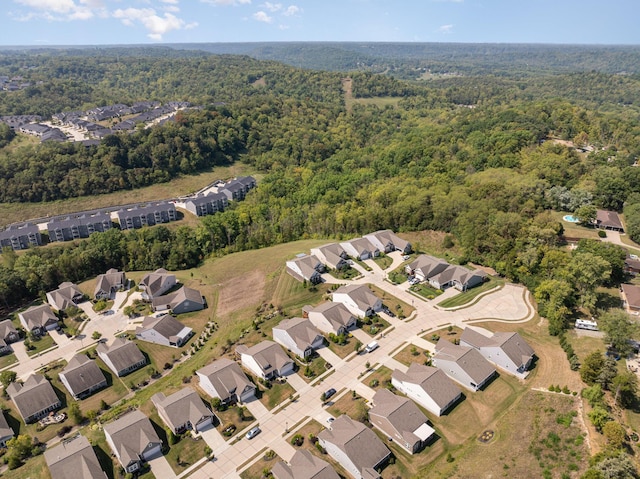 bird's eye view featuring a residential view and a wooded view