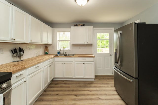 510 Fox St, Elsmere, KY 41018 - kitchen with stainless steel refrigerator with ice dispenser, butcher block counters, a sink, and decorative backsplash