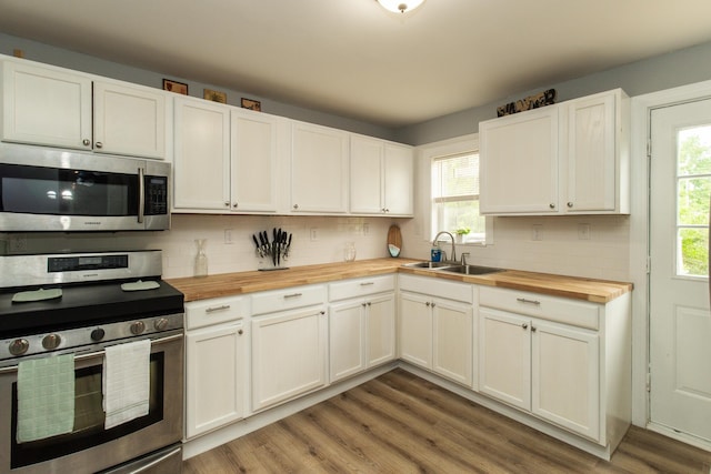 510 Fox St, Elsmere, KY 41018 - kitchen featuring wood counters, appliances with stainless steel finishes, a sink, tasteful backsplash, and light wood-type flooring