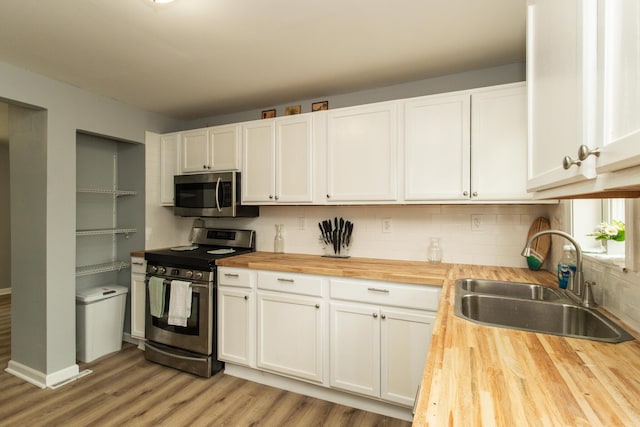 510 Fox St, Elsmere, KY 41018 - kitchen featuring butcher block countertops, appliances with stainless steel finishes, a sink, light wood-style flooring, and white cabinets