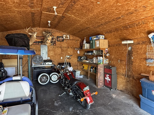 garage featuring a workshop area and electric panel