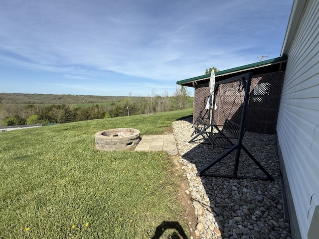 view of yard with an outdoor fire pit