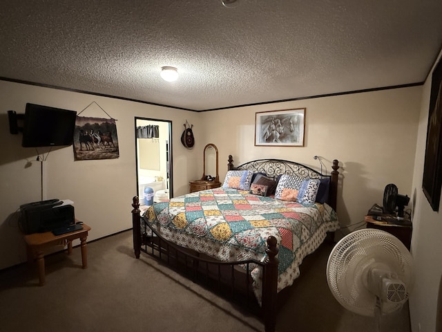 bedroom featuring a textured ceiling and carpet flooring