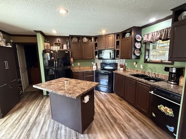kitchen with black appliances, open shelves, a textured ceiling, and a sink