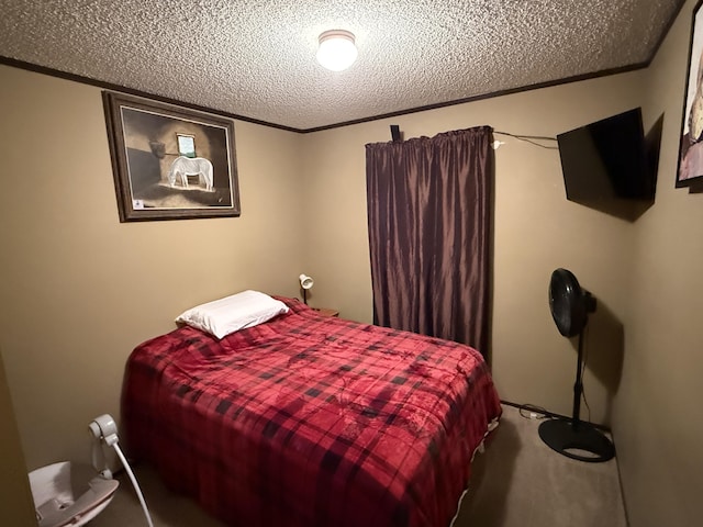 carpeted bedroom with a textured ceiling and ornamental molding