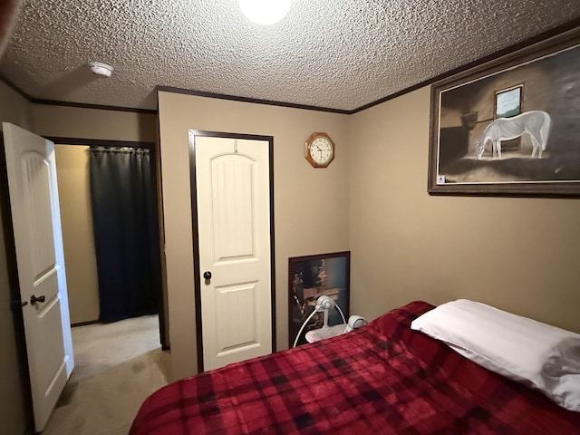 carpeted bedroom featuring a textured ceiling