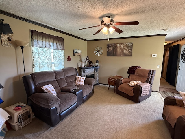 living room with ornamental molding, ceiling fan, and a textured ceiling
