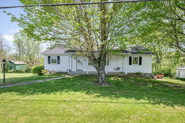 view of front of property featuring covered porch and a front lawn