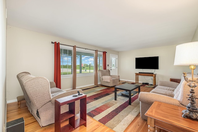 living room featuring light wood-style floors and baseboards