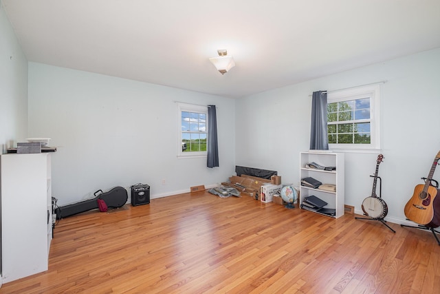 miscellaneous room featuring light wood-type flooring, baseboards, and plenty of natural light