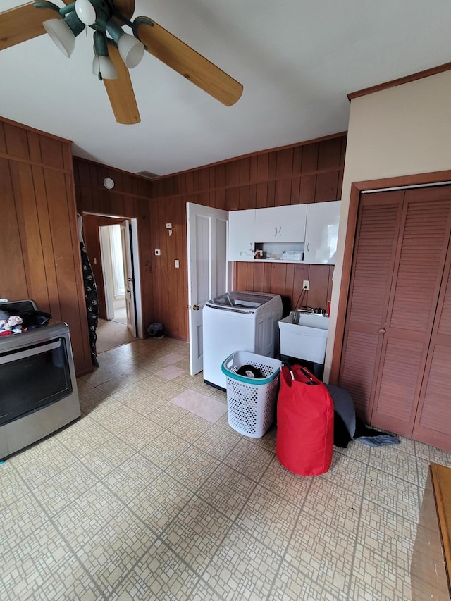 103 N Main St, Crittenden, KY 41030 - kitchen with range, washer / clothes dryer, a sink, ceiling fan, and wooden walls