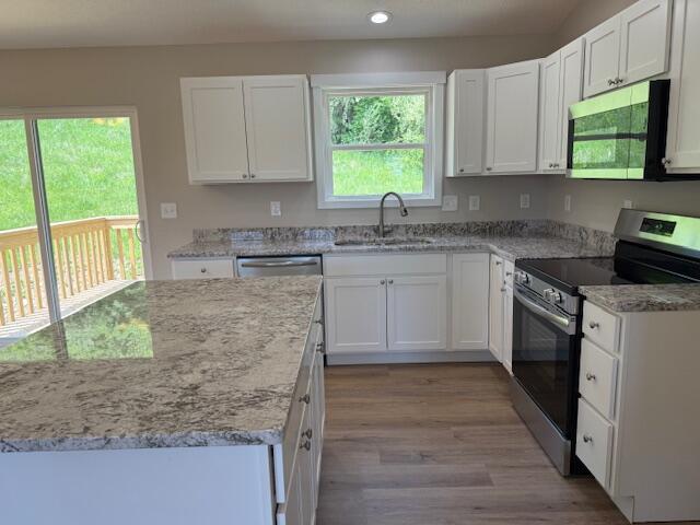 kitchen featuring a sink, white cabinets, and stainless steel appliances
