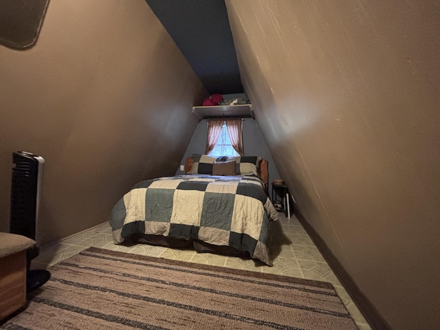 bedroom with carpet and lofted ceiling