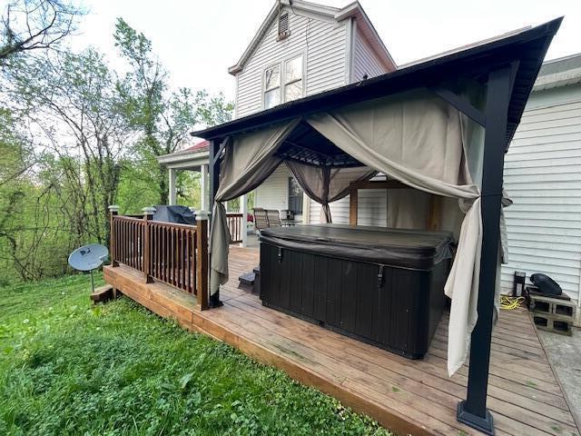 deck featuring a hot tub