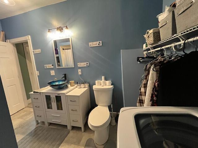 bathroom featuring toilet and vanity