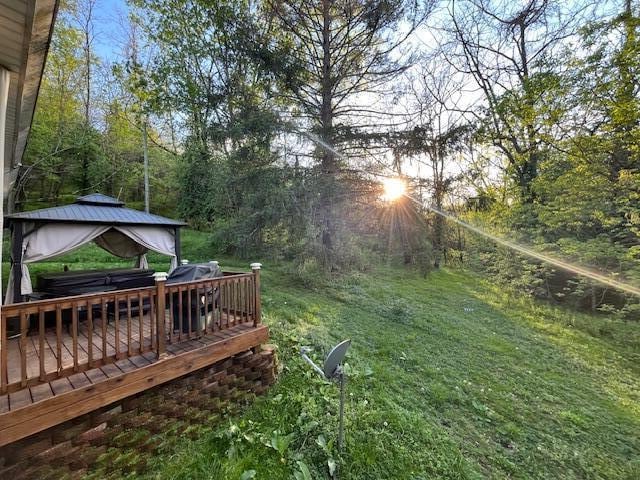view of yard featuring a wooden deck and a gazebo