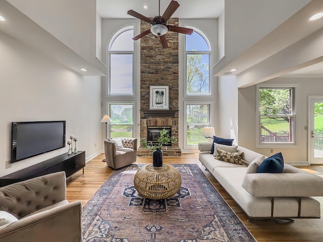living area featuring ceiling fan, a healthy amount of sunlight, and wood finished floors