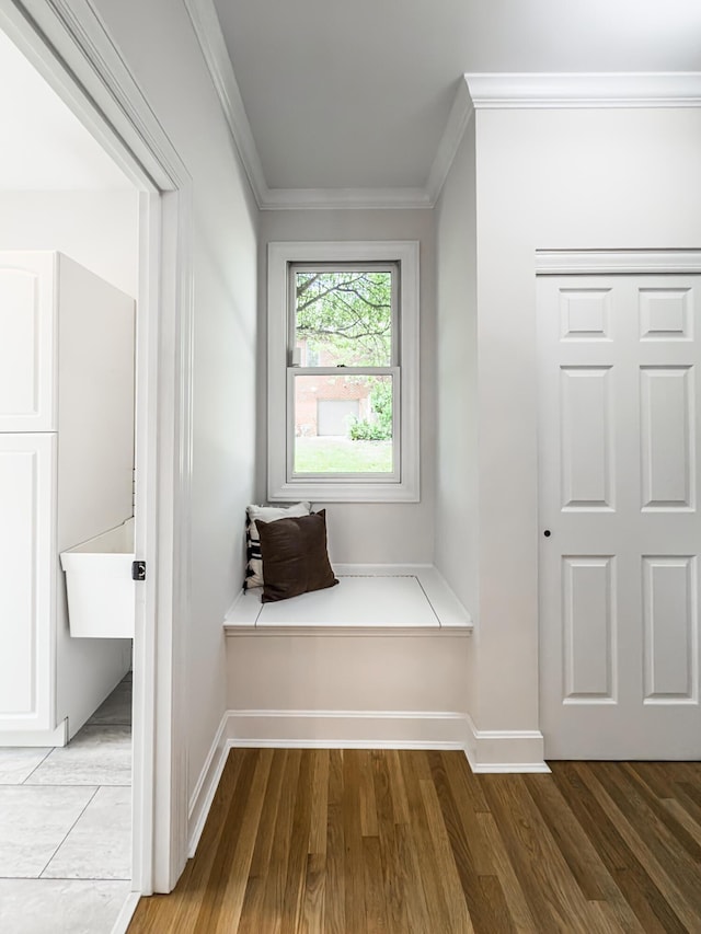 mudroom featuring baseboards, ornamental molding, and wood finished floors