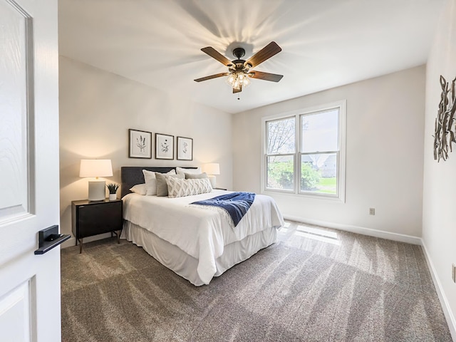 bedroom featuring dark carpet, baseboards, and ceiling fan