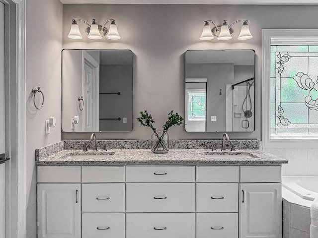 bathroom featuring plenty of natural light, a sink, and double vanity