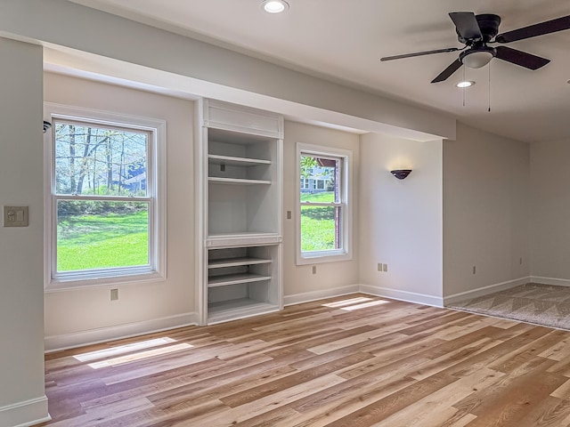 unfurnished living room with recessed lighting, baseboards, a healthy amount of sunlight, and light wood-style floors