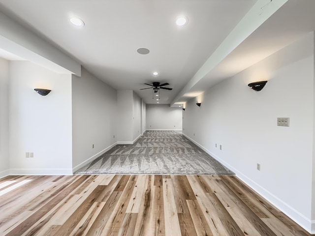 interior space featuring recessed lighting, baseboards, and wood finished floors