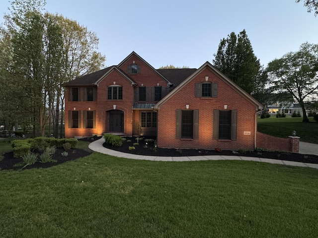 view of front of house with brick siding and a front yard