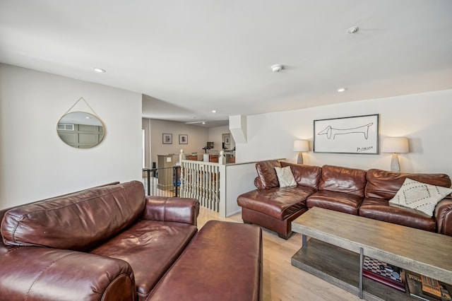 living room with light wood finished floors and recessed lighting