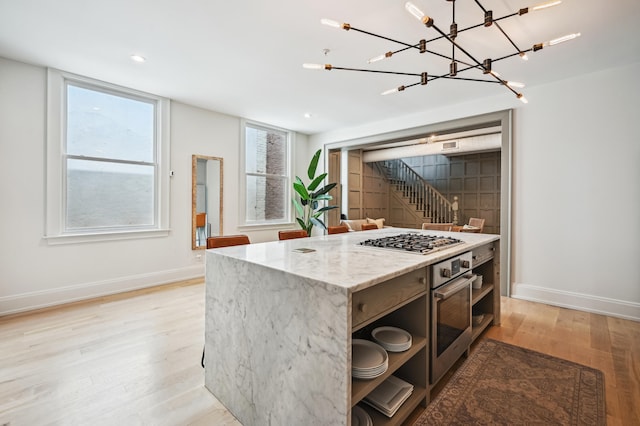 kitchen featuring an inviting chandelier, light wood-style flooring, open shelves, baseboards, and appliances with stainless steel finishes