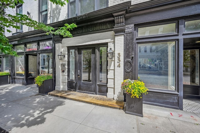 doorway to property featuring brick siding