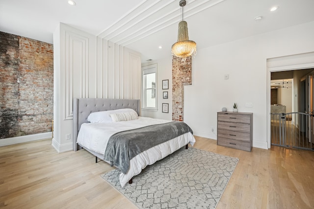 bedroom with light wood-style floors, baseboards, and recessed lighting